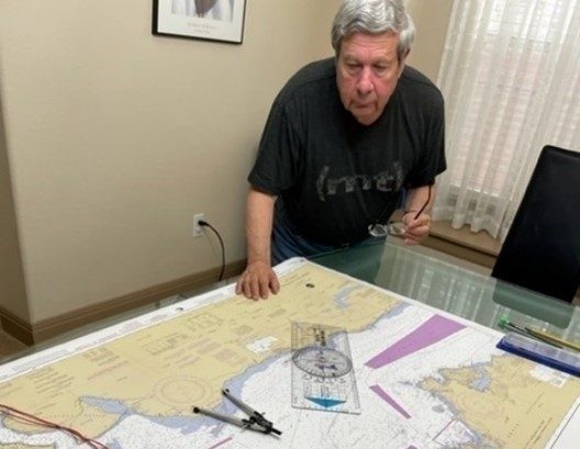 Bob Rein working with navigation charts